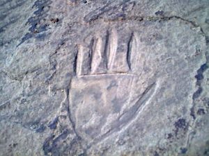 Hands carving on rock 1